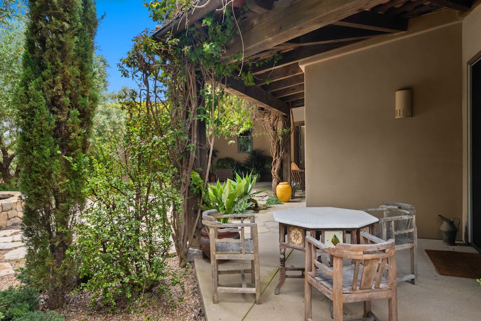 Cozy rustic patio space with vintage furniture and lush greenery